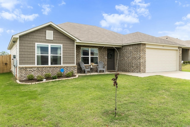 view of front of house featuring a garage, a front lawn, fence, brick siding, and driveway