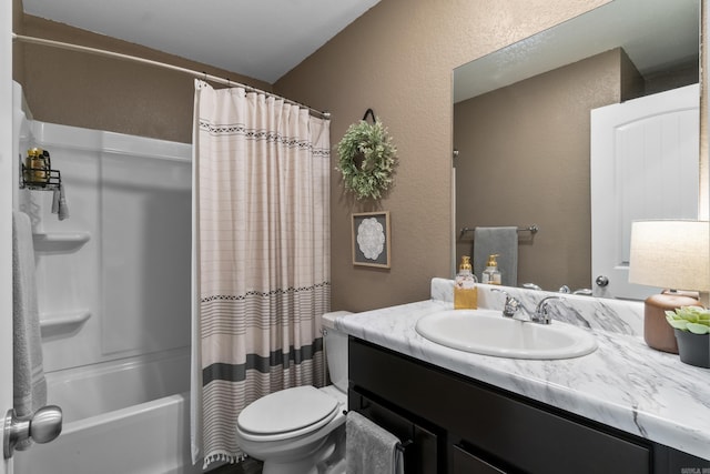 full bathroom featuring vanity, a textured wall, shower / bath combination with curtain, and toilet