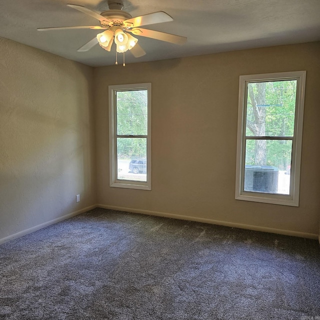 empty room with baseboards, carpet flooring, and a ceiling fan