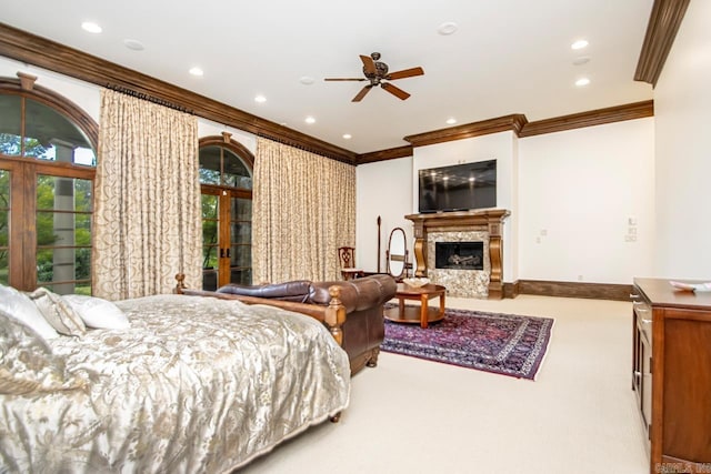 carpeted bedroom featuring french doors, recessed lighting, baseboards, ornamental molding, and a high end fireplace