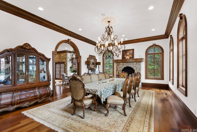 dining area with crown molding, wood-type flooring, a notable chandelier, and recessed lighting