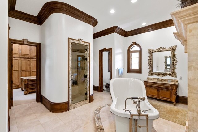 bathroom with recessed lighting, baseboards, a shower stall, crown molding, and a freestanding bath