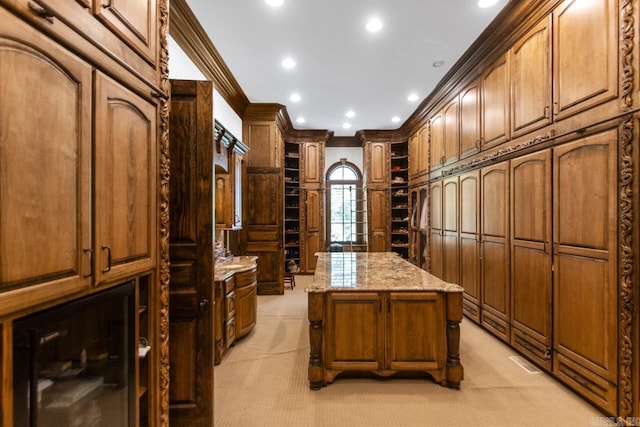 walk in closet with light colored carpet, wine cooler, and visible vents