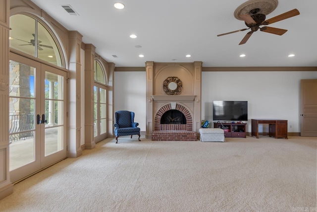 living room featuring french doors, ceiling fan, and light colored carpet