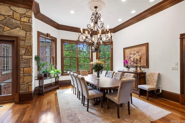 dining area with hardwood / wood-style floors, ornamental molding, recessed lighting, a chandelier, and baseboards
