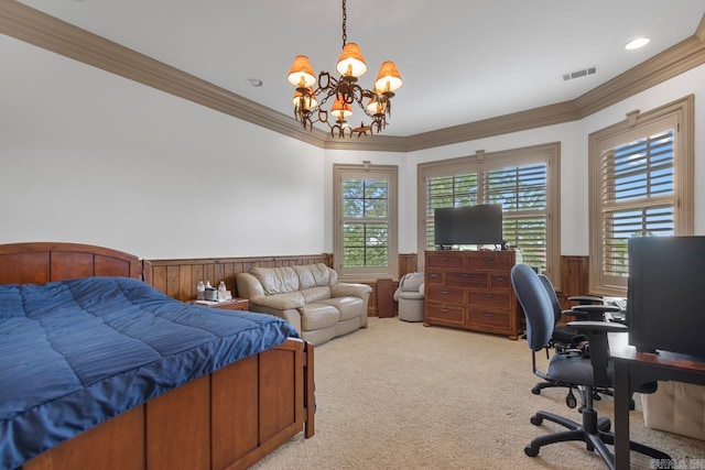 bedroom featuring crown molding, light carpet, and a wainscoted wall