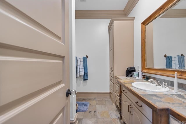 bathroom with crown molding, vanity, and stone finish flooring