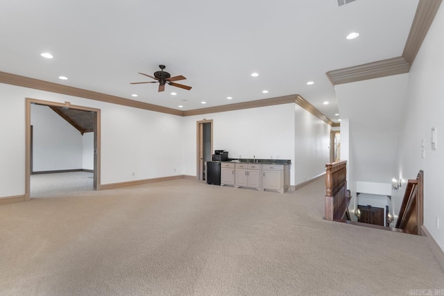 unfurnished living room with light colored carpet, ornamental molding, and recessed lighting