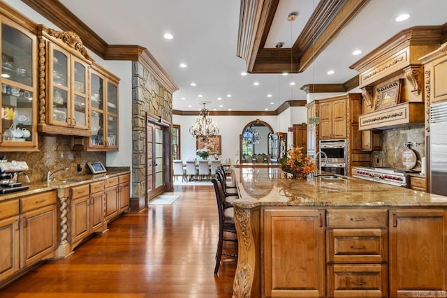 kitchen featuring a large island, ornamental molding, dark wood finished floors, and tasteful backsplash