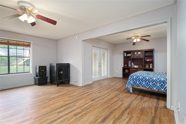 bedroom with ceiling fan, access to outside, baseboards, and wood finished floors
