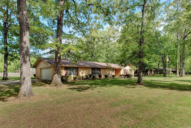 ranch-style home with a front lawn and a garage