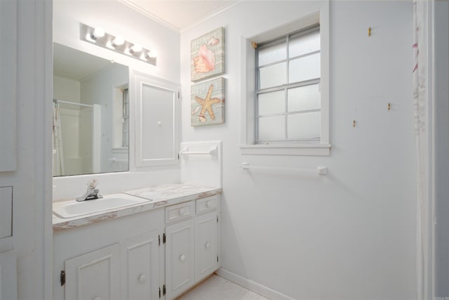 bathroom with vanity, ornamental molding, a shower with curtain, and baseboards