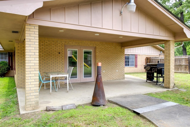 view of patio / terrace with fence, french doors, and a grill