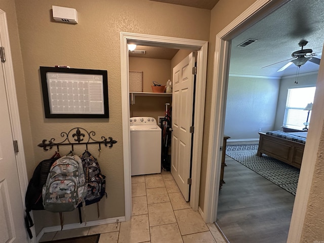 corridor with washer / dryer and visible vents