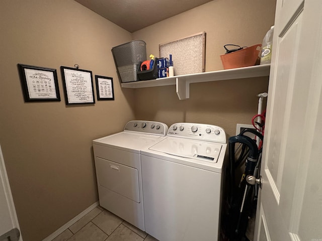 washroom featuring baseboards, laundry area, independent washer and dryer, and light tile patterned flooring