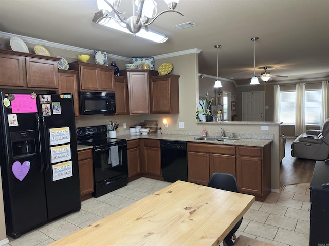 kitchen with a peninsula, light tile patterned floors, black appliances, and a sink
