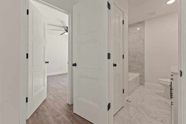 bathroom featuring toilet, marble finish floor, recessed lighting, ceiling fan, and baseboards