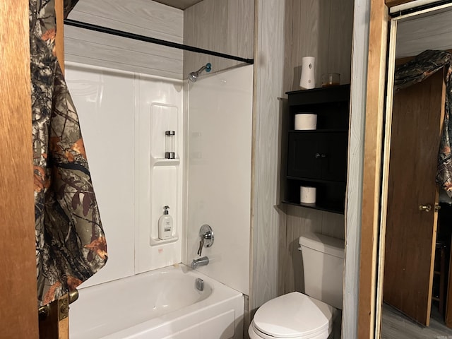 full bathroom featuring shower / bath combination with curtain and toilet