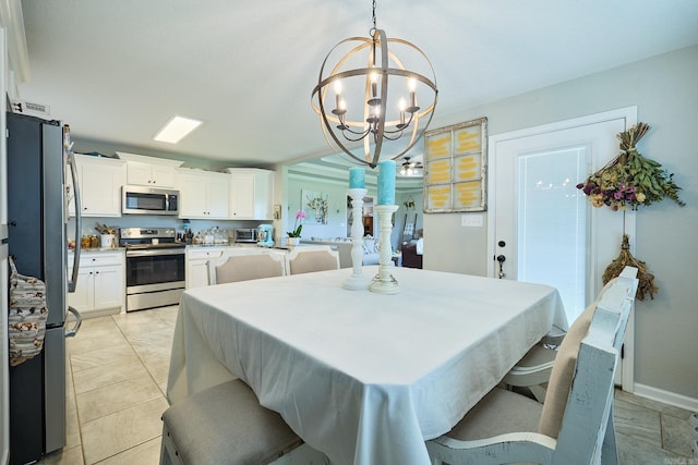 dining area featuring an inviting chandelier and baseboards