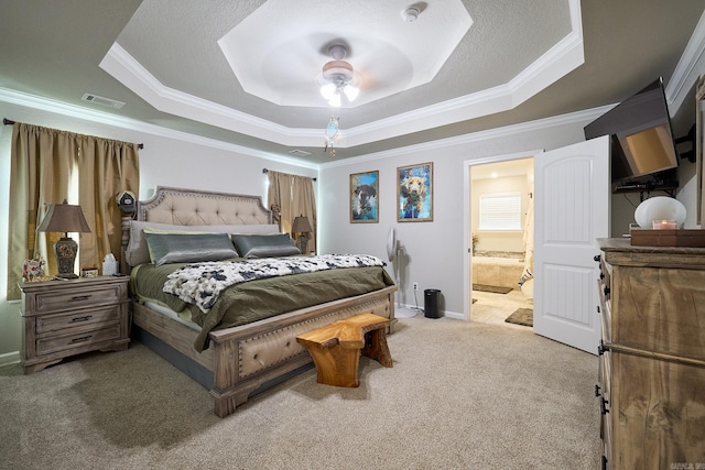 bedroom with carpet flooring, visible vents, a raised ceiling, and ornamental molding