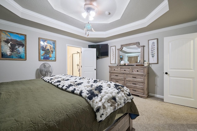 bedroom featuring light colored carpet, crown molding, a ceiling fan, and a tray ceiling