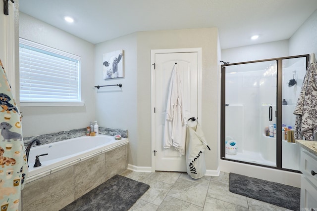 bathroom featuring a garden tub, a stall shower, tile patterned floors, baseboards, and vanity