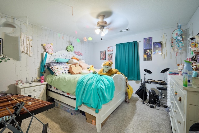 bedroom featuring ceiling fan, visible vents, and carpet