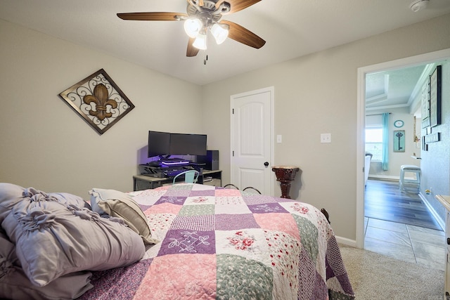 carpeted bedroom with baseboards and a ceiling fan