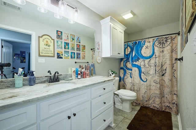 bathroom featuring toilet, tile patterned flooring, vanity, and visible vents