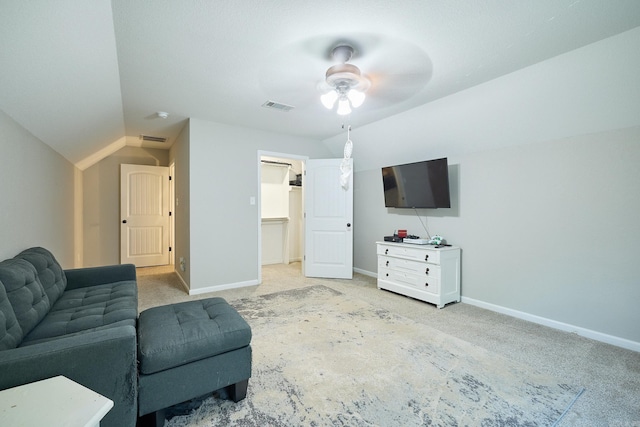 living room featuring visible vents, baseboards, ceiling fan, and light carpet