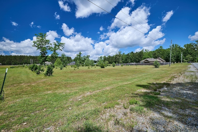 view of yard with a rural view and fence