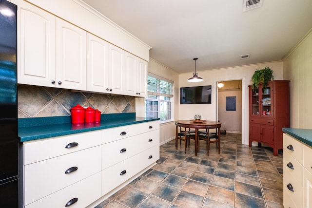 kitchen featuring dark countertops, white cabinetry, visible vents, and tasteful backsplash