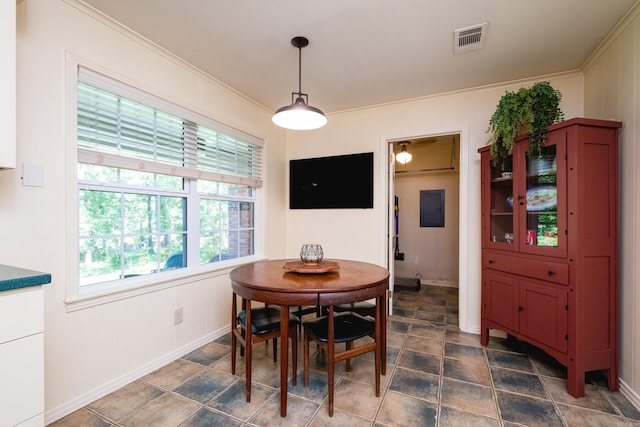dining space featuring baseboards, ornamental molding, and visible vents