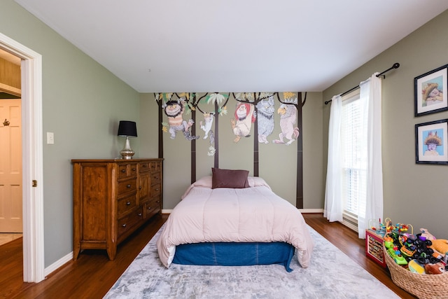 bedroom with baseboards and dark wood finished floors