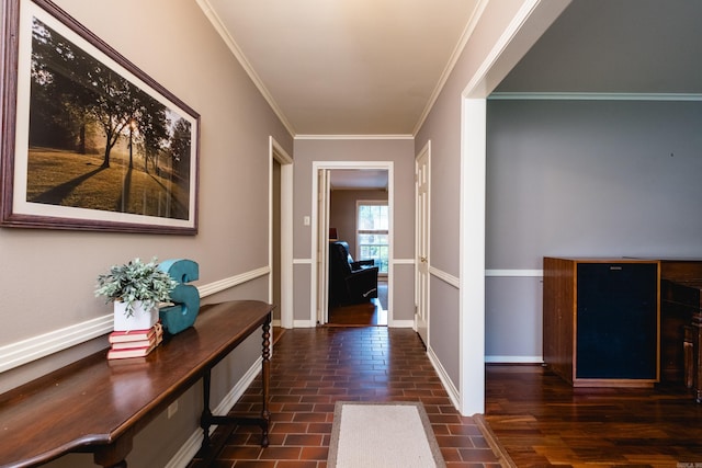 corridor with crown molding, baseboards, and brick floor