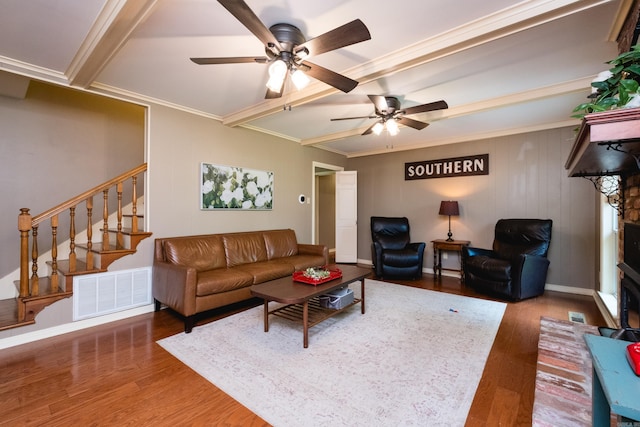 living area with ceiling fan, visible vents, stairs, wood finished floors, and beamed ceiling