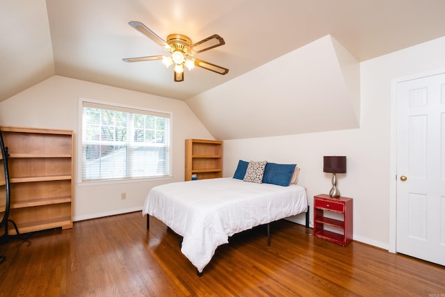 bedroom featuring ceiling fan, lofted ceiling, baseboards, and wood finished floors