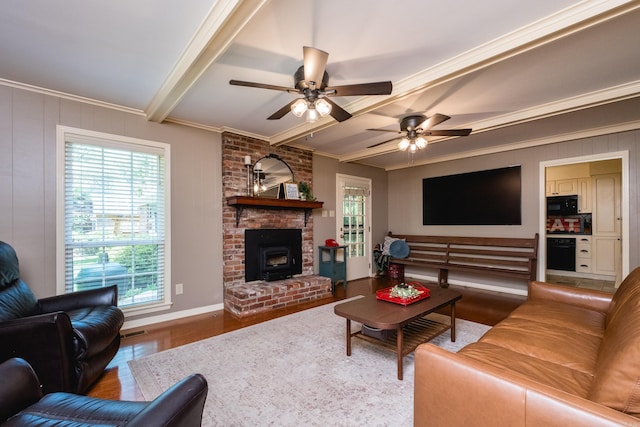 living room with a ceiling fan, ornamental molding, baseboards, and wood finished floors