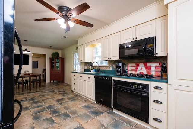 kitchen with a sink, black appliances, decorative backsplash, white cabinets, and dark countertops