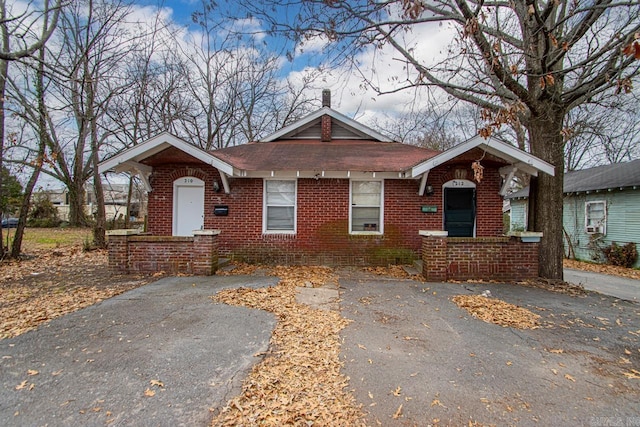 210 W 18th St, North Little Rock, AR 72114 - view of front facade with a shingled roof, brick siding, and aphalt driveway