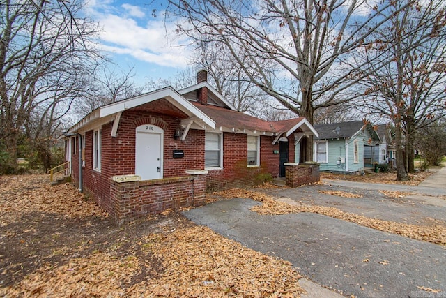 210 W 18th St, North Little Rock, AR 72114 - view of front of house with a chimney and brick siding