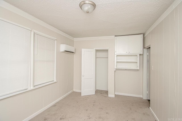 210 W 18th St, North Little Rock, AR 72114 - unfurnished bedroom featuring a closet, a textured ceiling, a wall mounted AC, light carpet, and ornamental molding
