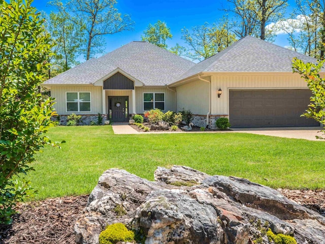 single story home with a front yard, a shingled roof, and a garage