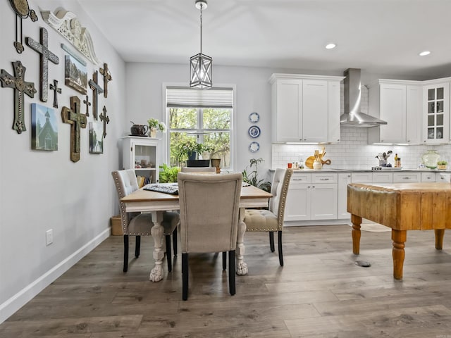 dining area with baseboards, recessed lighting, and wood finished floors