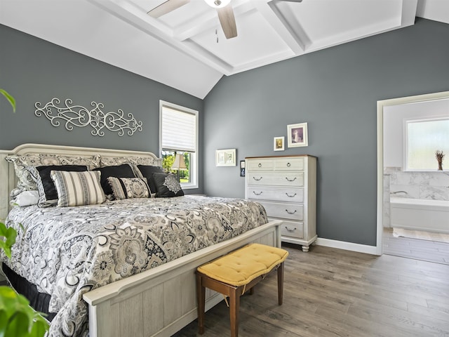 bedroom with lofted ceiling with beams, wood finished floors, baseboards, and multiple windows