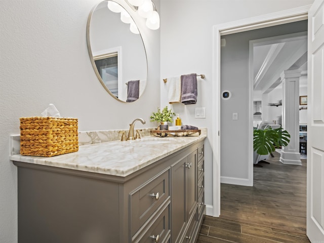 bathroom with baseboards, vanity, and wood finished floors