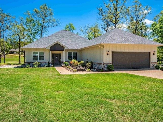 view of front facade with driveway, brick siding, a garage, a front yard, and roof with shingles