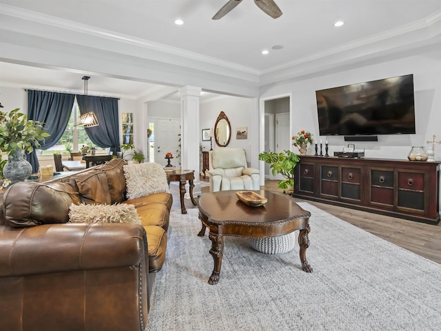 living room featuring wood finished floors, a ceiling fan, ornate columns, ornamental molding, and recessed lighting