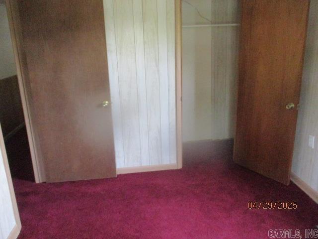 unfurnished bedroom featuring carpet and a closet