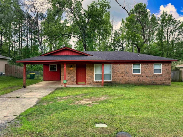 ranch-style house featuring fence, an attached carport, brick siding, and driveway